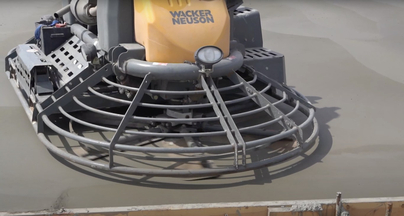 Power trowel finishing concrete slab in Delano, CA